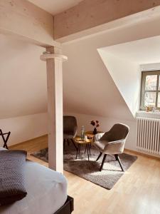 a bedroom with a bed and two chairs and a table at Apartment Altstadt Freiberg in Freiberg