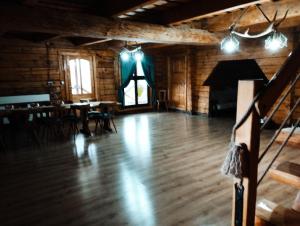 a large room with a wooden floor and a stage at Cabana Kraus in Valea Vişeului