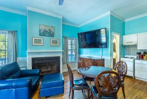 a living room with blue walls and a table and a couch at St George Inn in St. George Island