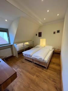 a large bedroom with a large bed and a window at Gasthaus Zum Goldenen Hirsch in Schriesheim