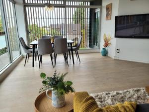 a living room with a table and chairs at Sunset Beach Paradise St Kilda in Melbourne