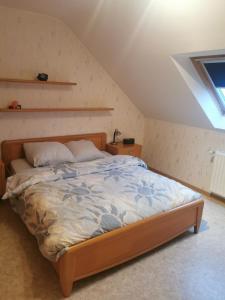 a bedroom with a large bed in a attic at Appartement Huldange in Huldange