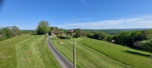 an aerial view of a road in a field with houses at Le Champêtre in Vézac