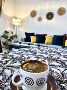 a cup of coffee sitting on a tray on a bed at Villa Merci Budva in Budva