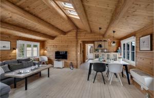 a log cabin living room with a table and a couch at Cozy Home In Gilleleje With Kitchen in Gilleleje