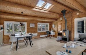 a living room with a fireplace in a log cabin at Cozy Home In Gilleleje With Kitchen in Gilleleje