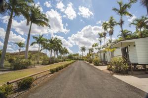 a house and a road with palm trees at Discovery Parks - Argylla in Mount Isa