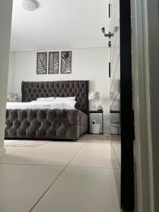 um quarto com uma cama grande num quarto branco em DEE-LOFT 53 em Windhoek