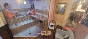un hombre y una mujer sentados en una sauna en Margaux B&B Babbita, en Stokrooie