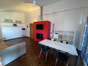 a living room with a table and chairs and a red cabinet at Casa Morena near Anagnina metro in Rome