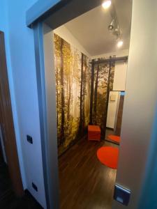 a room with a wall with a painting of trees at Casa Morena near Anagnina metro in Rome