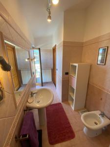 a bathroom with a sink and a toilet at Casa Morena near Anagnina metro in Rome