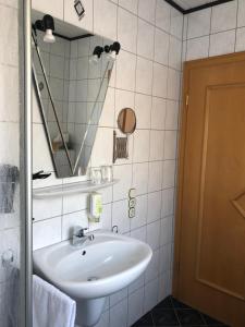 a bathroom with a white sink and a mirror at Weingut Lehnert-Später in Piesport