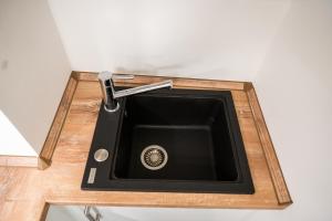 a black kitchen sink on a wooden counter at JAWO Apartments Koblenz modern & zentral, Küche & WIFI in Koblenz