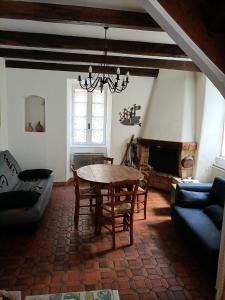 a living room with a table and a couch at Maison Antraigues sur Volane in Asperjoc