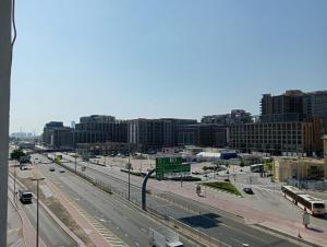 a view of a city with a highway and buses at Silver Sand Hotel in Dubai