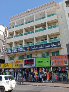 a building with shops on the side of a street at Silver Sand Hotel in Dubai