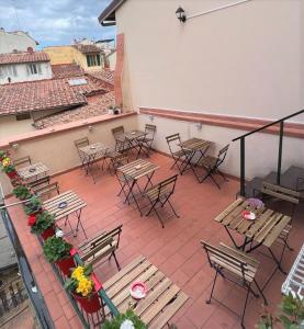 a patio with tables and chairs on a building at Emerald Palace Family Hostel in Florence