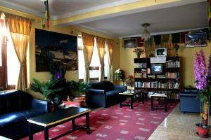 a living room with couches and a book shelf at Elbrus Home in Kathmandu