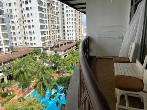 a balcony with a view of a pool and buildings at Lovely 1-Bedroom Condo with Facilities in Malacca