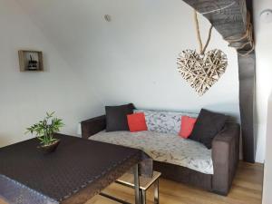 a living room with a couch and a table at Ecrin de bien-être au pays des couleurs in Saint-Victor-de-Morestel