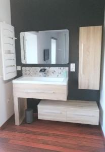 a bathroom with a white sink and a mirror at Ecrin de bien-être au pays des couleurs in Saint-Victor-de-Morestel
