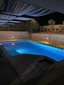 a swimming pool under a canopy at night at Villa Arena - pool table, table tennis, darts, pinball machine & more in Pula