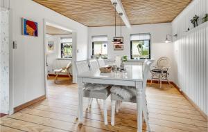 a white dining room with a white table and chairs at Beautiful Home In Hadsund With Wifi And 3 Bedrooms in Hadsund