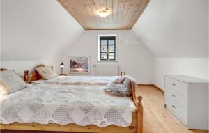 a white bedroom with a bed and a window at Beautiful Home In Hadsund With Wifi And 3 Bedrooms in Hadsund