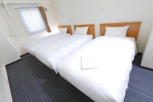 Postel nebo postele na pokoji v ubytování FLEXSTAY INN Tokiwadai
