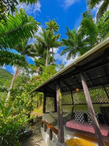 a resort with palm trees in the background at Cocoa Cottage in Roseau