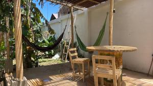 a patio with a table and chairs and a hammock at CASA PALUM Prívate Room share bathroom in Palomino