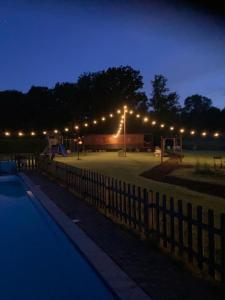 a parking lot with lights in a park at night at Pia B&B Babbita in Hasselt