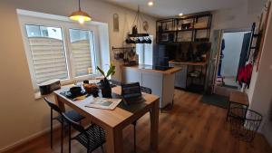 a kitchen with a table and chairs and a kitchen with a counter at alte Bäckerei Bautzen - 04 #Business# in Bautzen