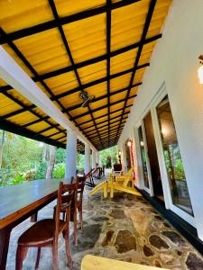 a dining room with a table and chairs at Whispering House in Tangalle