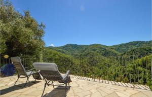 two chairs on a patio with mountains in the background at Gorgeous Apartment In Carcheto Brustico in Carcheto