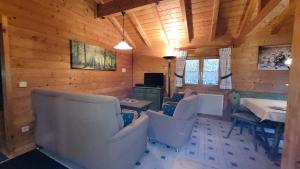 a room with chairs and a table in a cabin at Ferienhaus Chalet Blockhaus Bayern in Stamsried