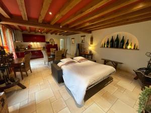 a bedroom with a bed and a living room at Le Gîte de Marie in Ludes