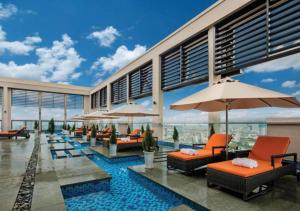 ein Resort mit einem Pool mit Stühlen und Sonnenschirmen in der Unterkunft Sunrise Luxury Apartment with Ocean View in Đà Nẵng