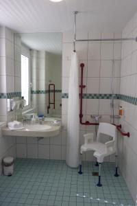 a bathroom with a shower and a sink and a tub at GesundheitsHotel Das Bad Peterstal in Bad Peterstal-Griesbach