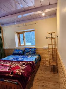 a bedroom with a large bed and a ladder at Neo Heaven's Stays BIR in Baijnāth
