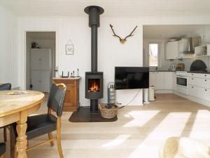 a kitchen with a wood stove in a living room at Holiday home Holbæk III in Holbæk