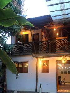 a house with a balcony with lights on it at Suite Casa PALUM Studio Apartment in Palomino