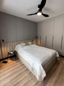 a bedroom with a bed and a ceiling fan at Apartamenty LUNA in Świeradów-Zdrój