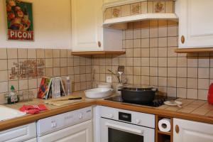 a kitchen with a counter top with a pot on the stove at Les Gites La Cerisaie in Breitenbach
