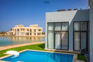 a house with a swimming pool next to a building at tawila t1-17 -5 bed room big villa in Hurghada