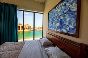 a bedroom with a bed and a large window at tawila t1-17 -5 bed room big villa in Hurghada