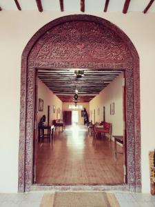 an archway leading into a room with tables and chairs at Hakuna Matata Villa in Paje