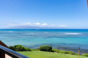 a view of the ocean from a balcony at Kuleana 613 1 Bdrm condo in Kahana