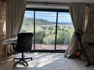 an office with a desk and a large window at Grand T2 bis avec terrasse et vue in Portel-des-Corbières